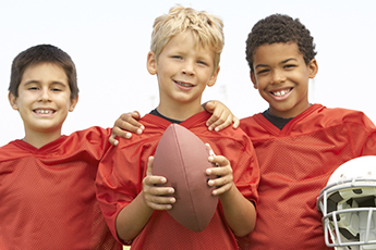 kids holding football 
